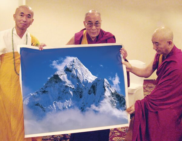The XIV Dalai Lama, a Nobel Peace Prize winner and spiritual leader of the Buddhists, posed with the photograph "Ama Dablam The Holy Mountain" by Sergey Melnikoff, a.k.a. MFF. New Delhi, 2007